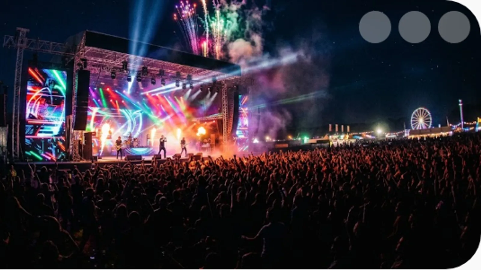 vibrant outdoor festival stage at night with colourful lighting and a crowd
