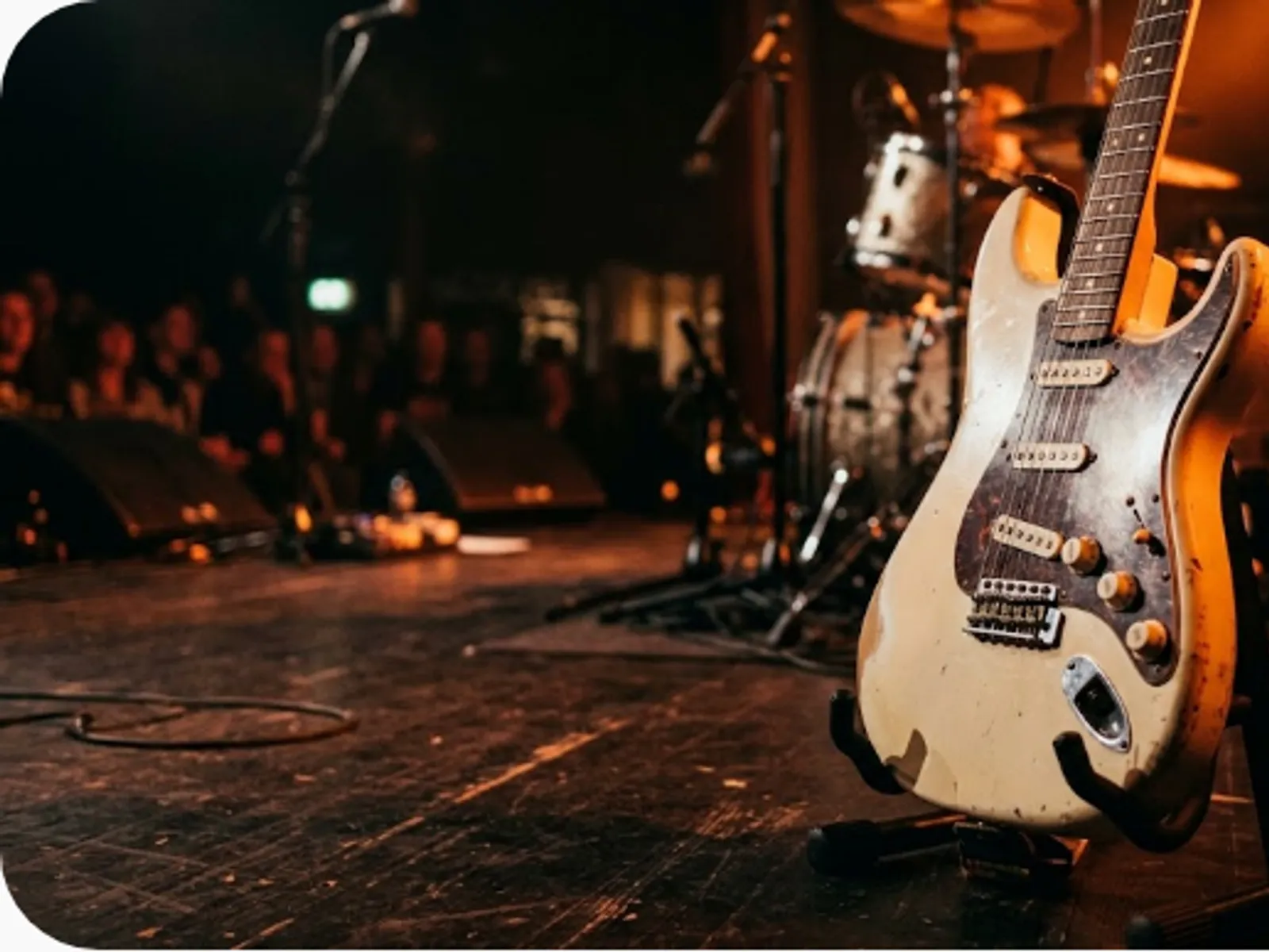 electric guitar on stage with warm rim lighting