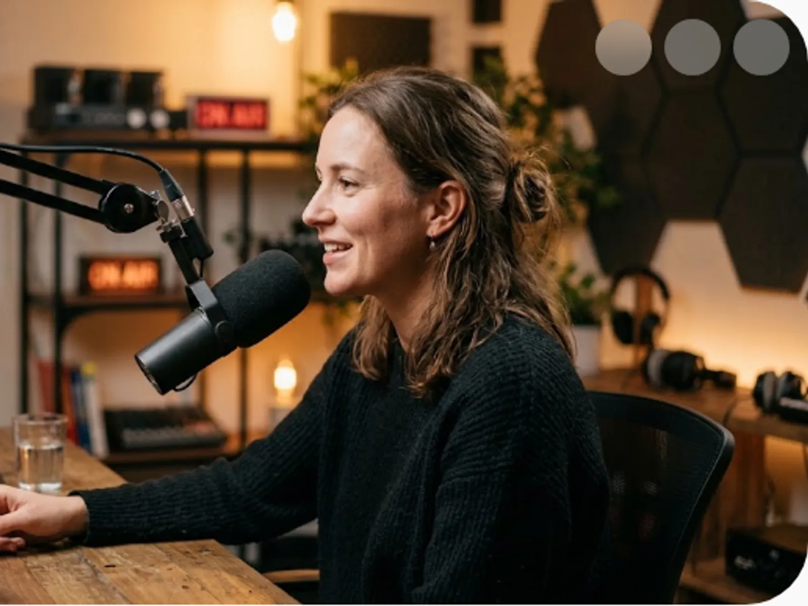 a podcast host speaking into a studio microphone